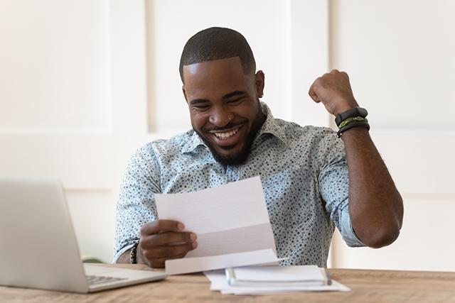 Man happy when opening paycheck