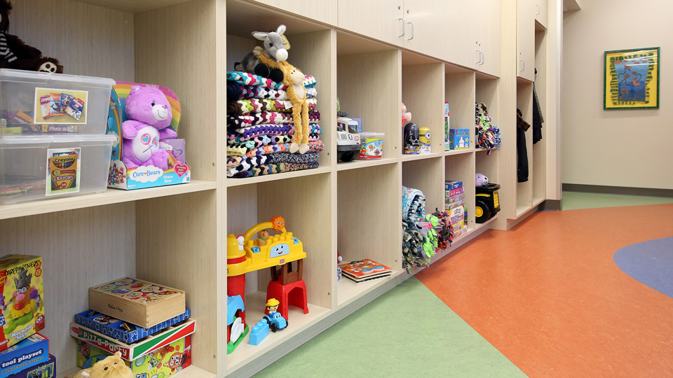 Interior of Secchia CarePartners waiting room, large shelves full of toys
