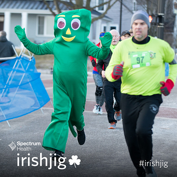 Person running in a Gumby costume