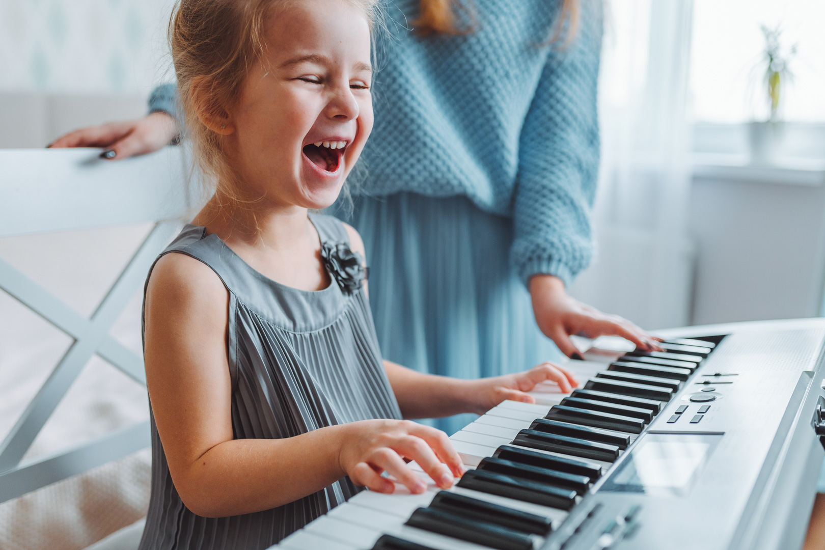 Smiling girl playing the piano