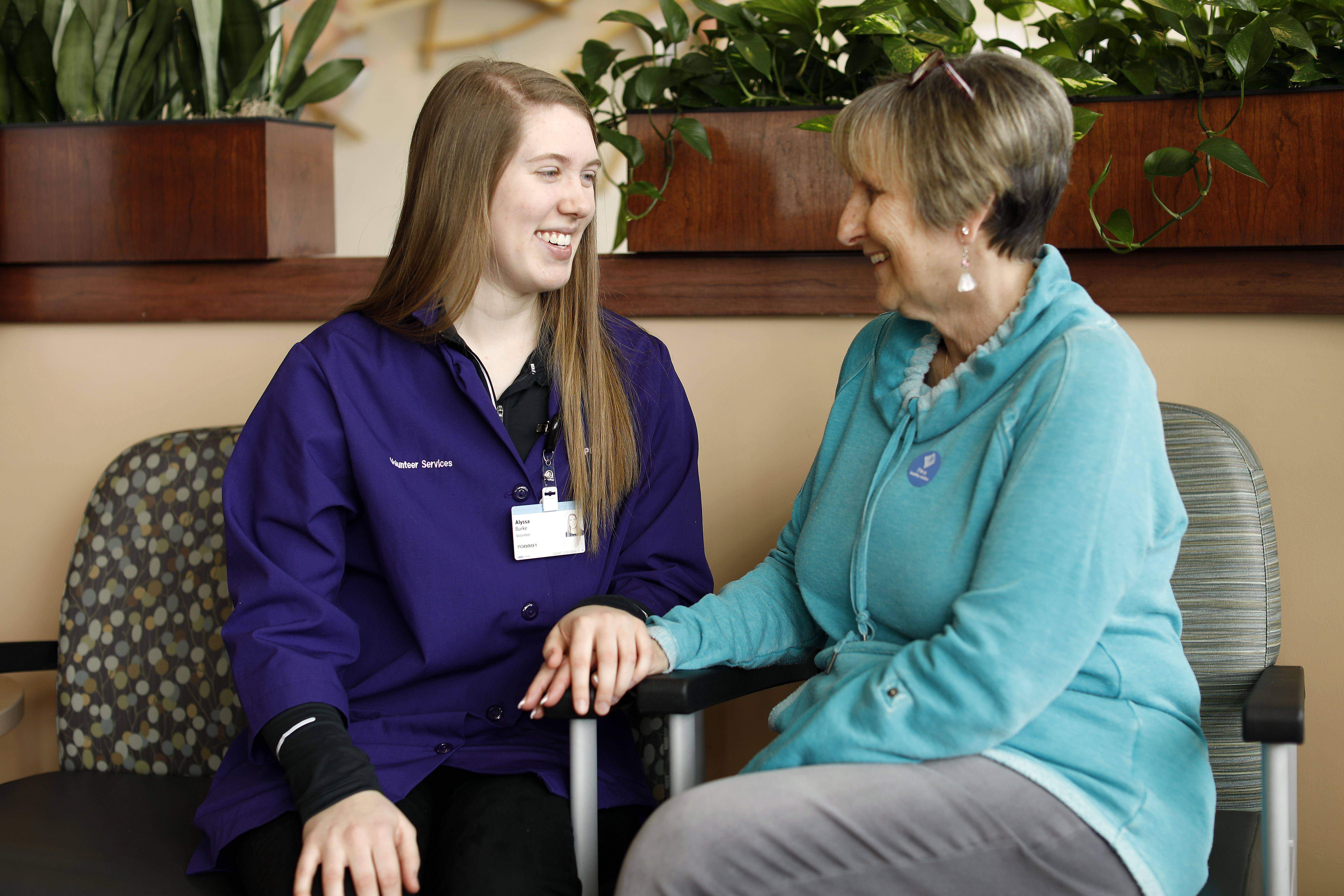 Volunteer kindly assisting a guest.