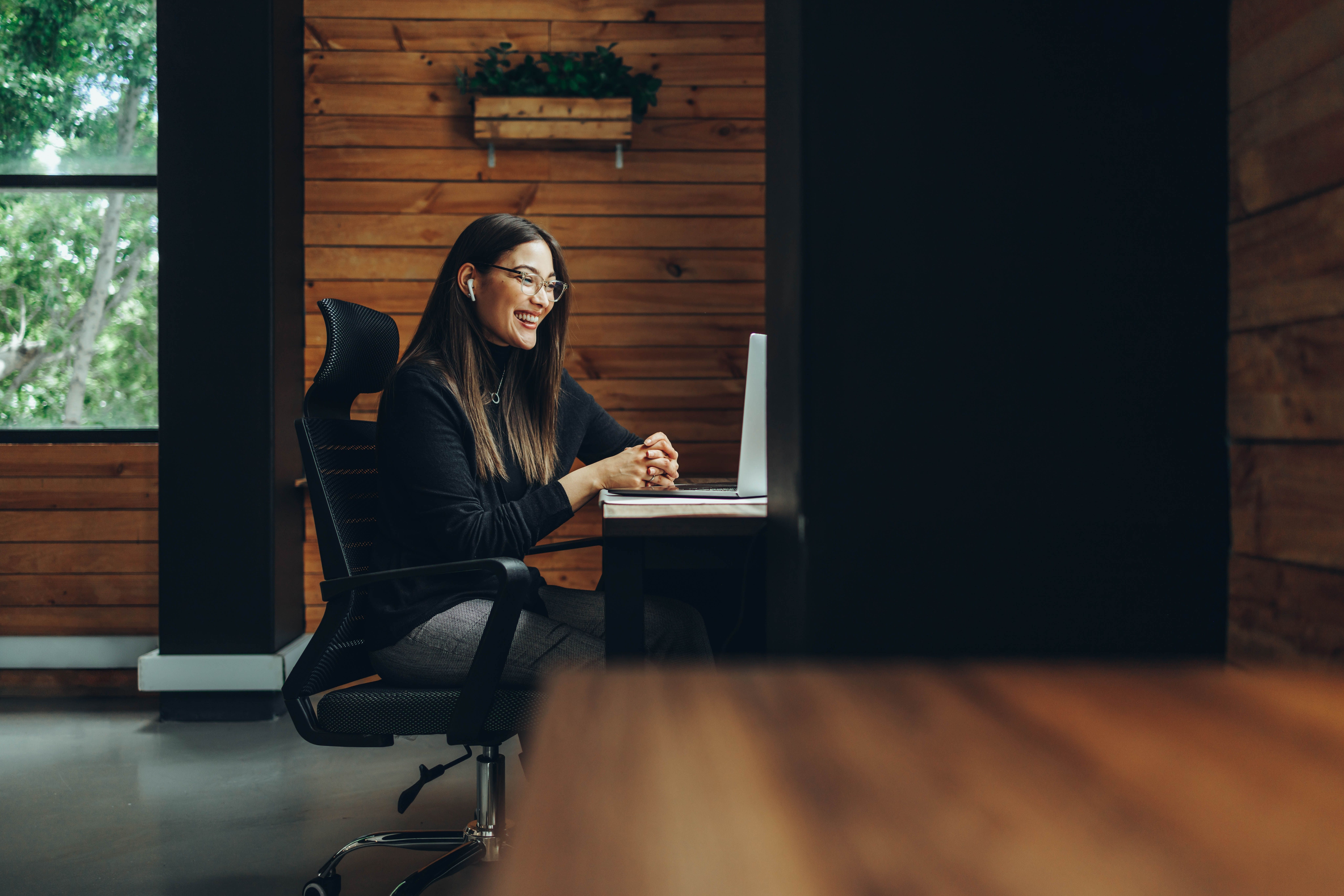 Woman in front of her laptop working remotely