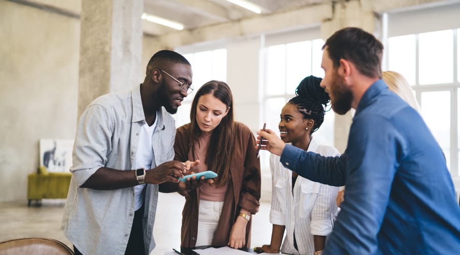 Coworkers around a table talking to each other