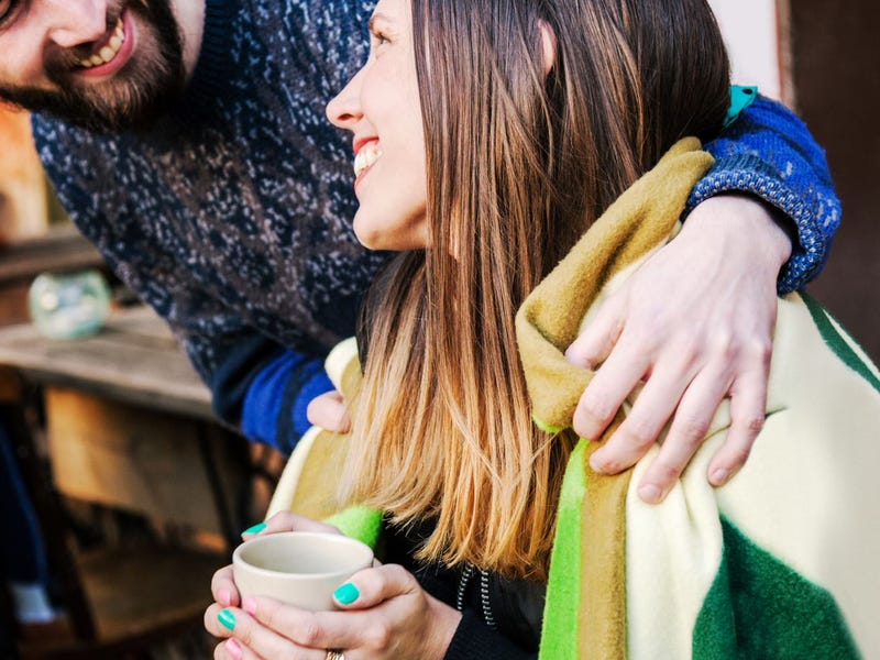 Woman saying thank you in French to a man who gave her a blanket while she was drinking coffee