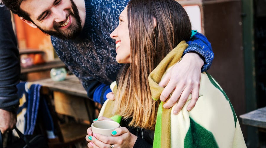Woman saying thank you in French to a man who gave her a blanket while she was drinking coffee