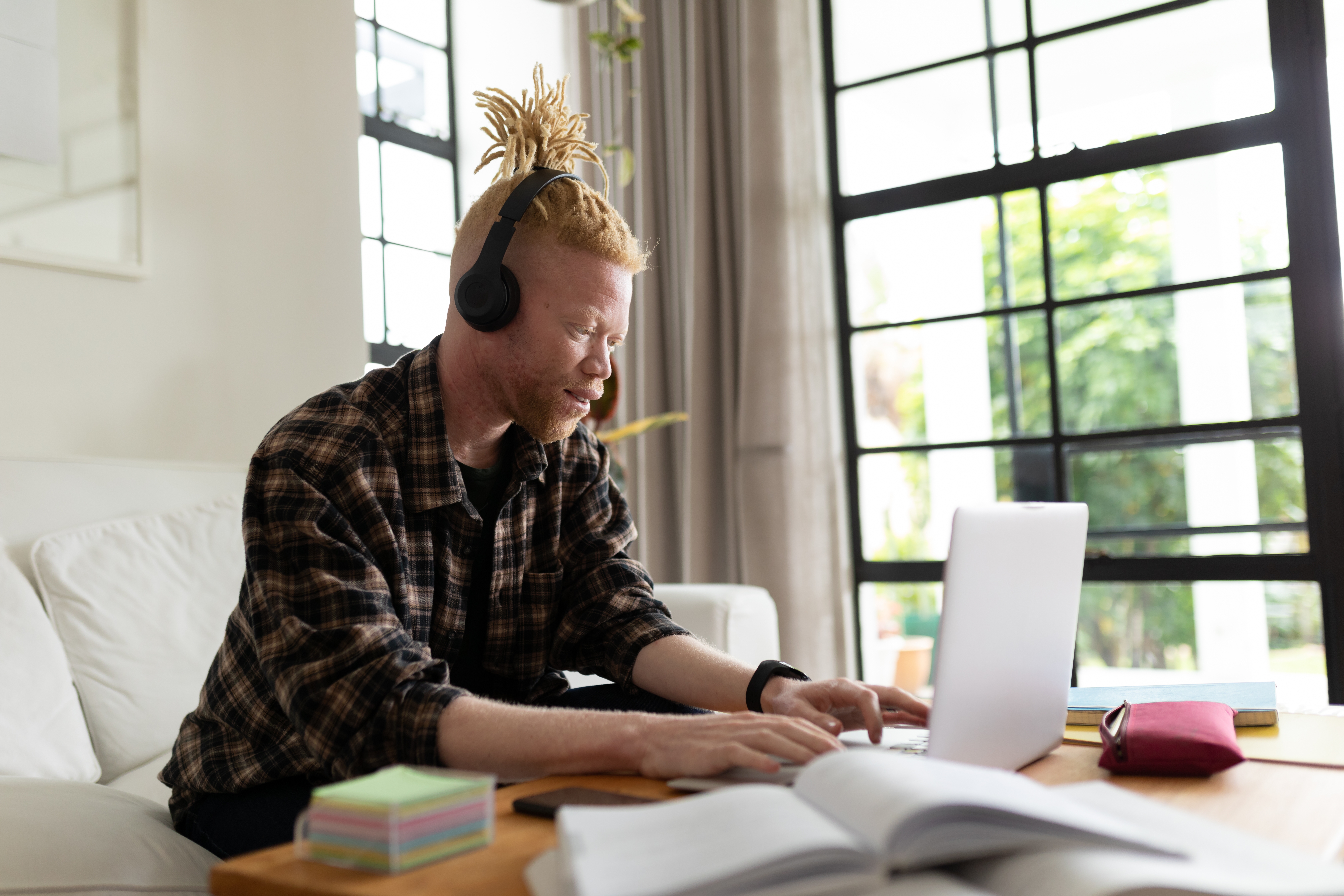 Man with headphones learning a langauge with Berlitz's AI tools online