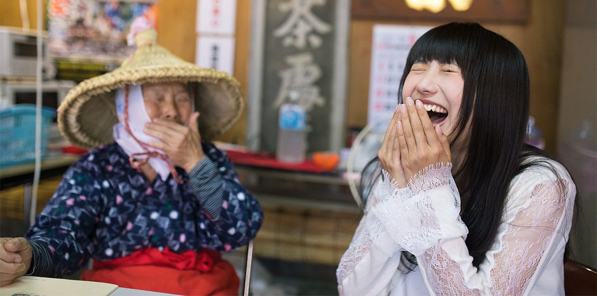 An elderly and a young woman laughing