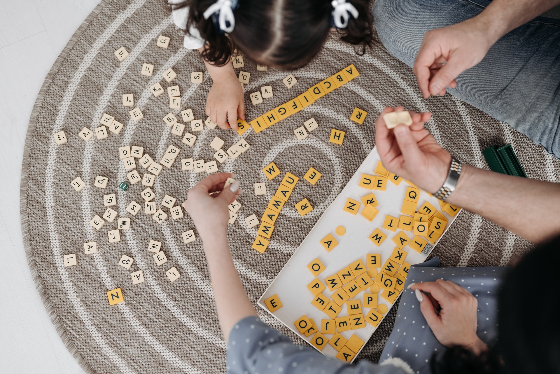 A family playing with Scrabble