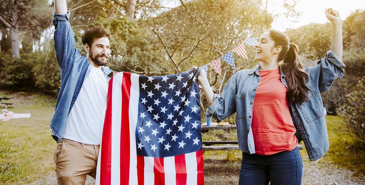 Couple with the American flag celebrating Independence Day