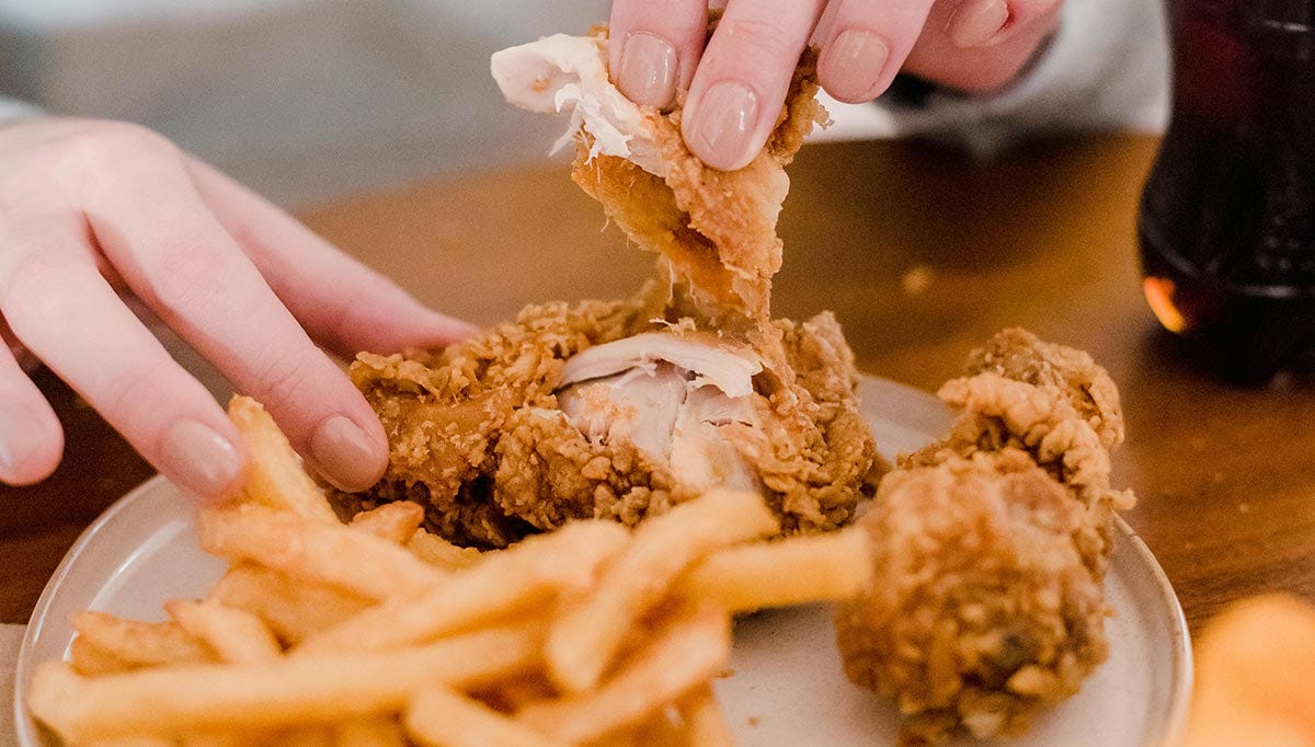 Woman eating fried chicken