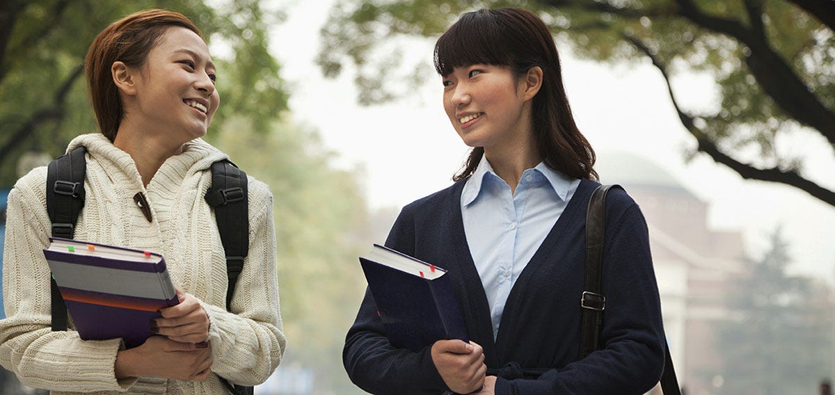 Woman starting a conversation with another woman in a park 