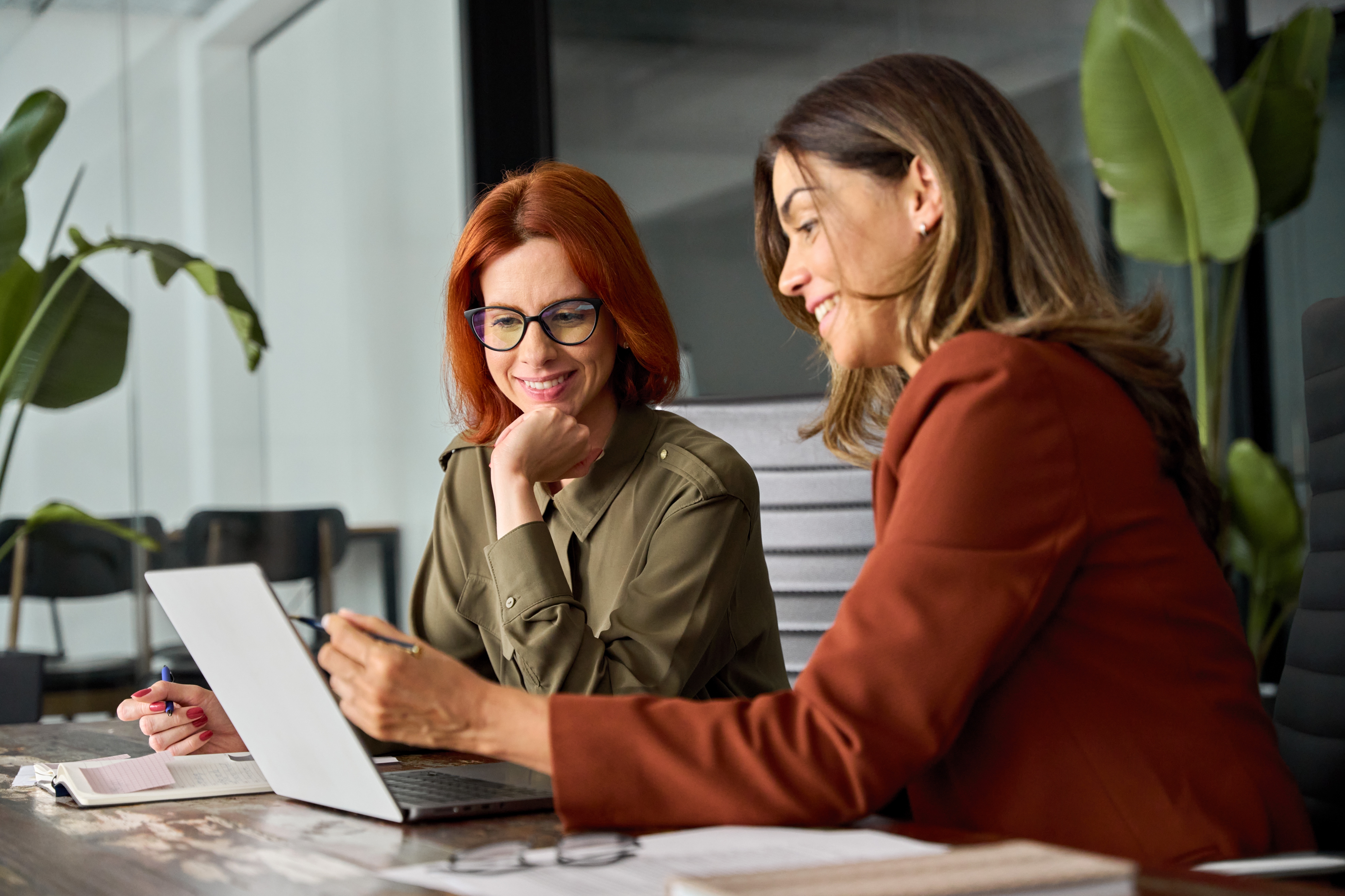 Woman learning English with a Berlitz instructor in front of a laptop