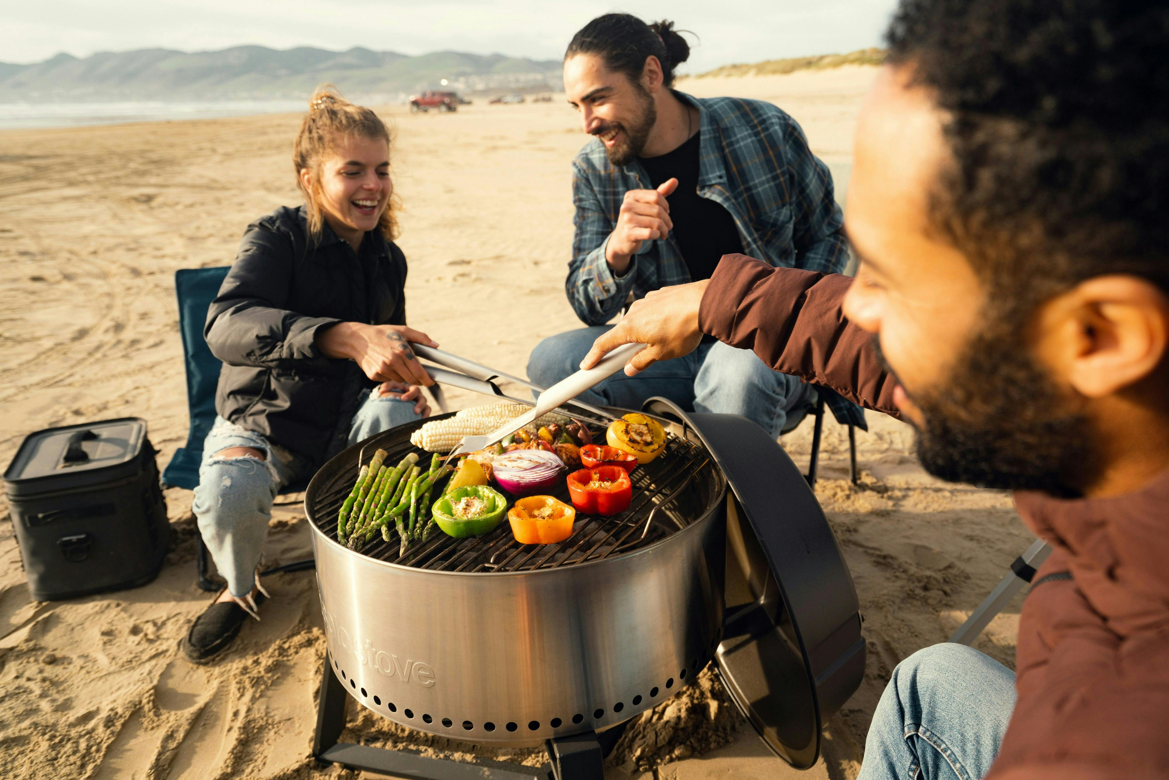 Friend group grilling on an Australian beach