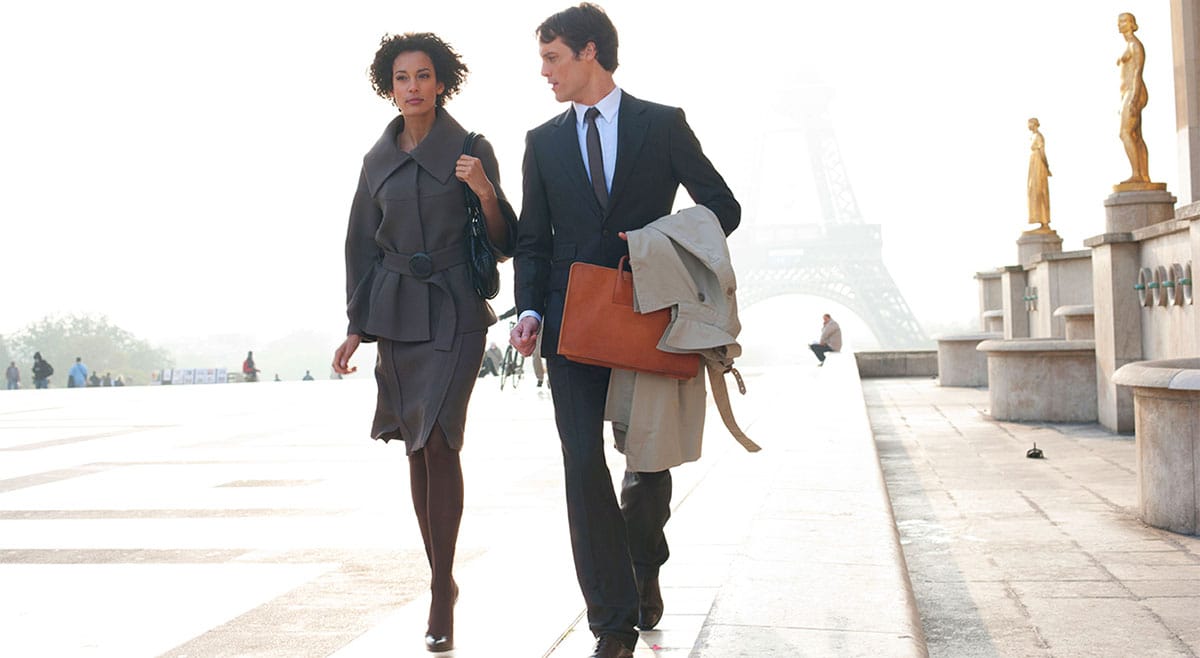 Businesswoman and businessman in a nice business attire walking and chatting
