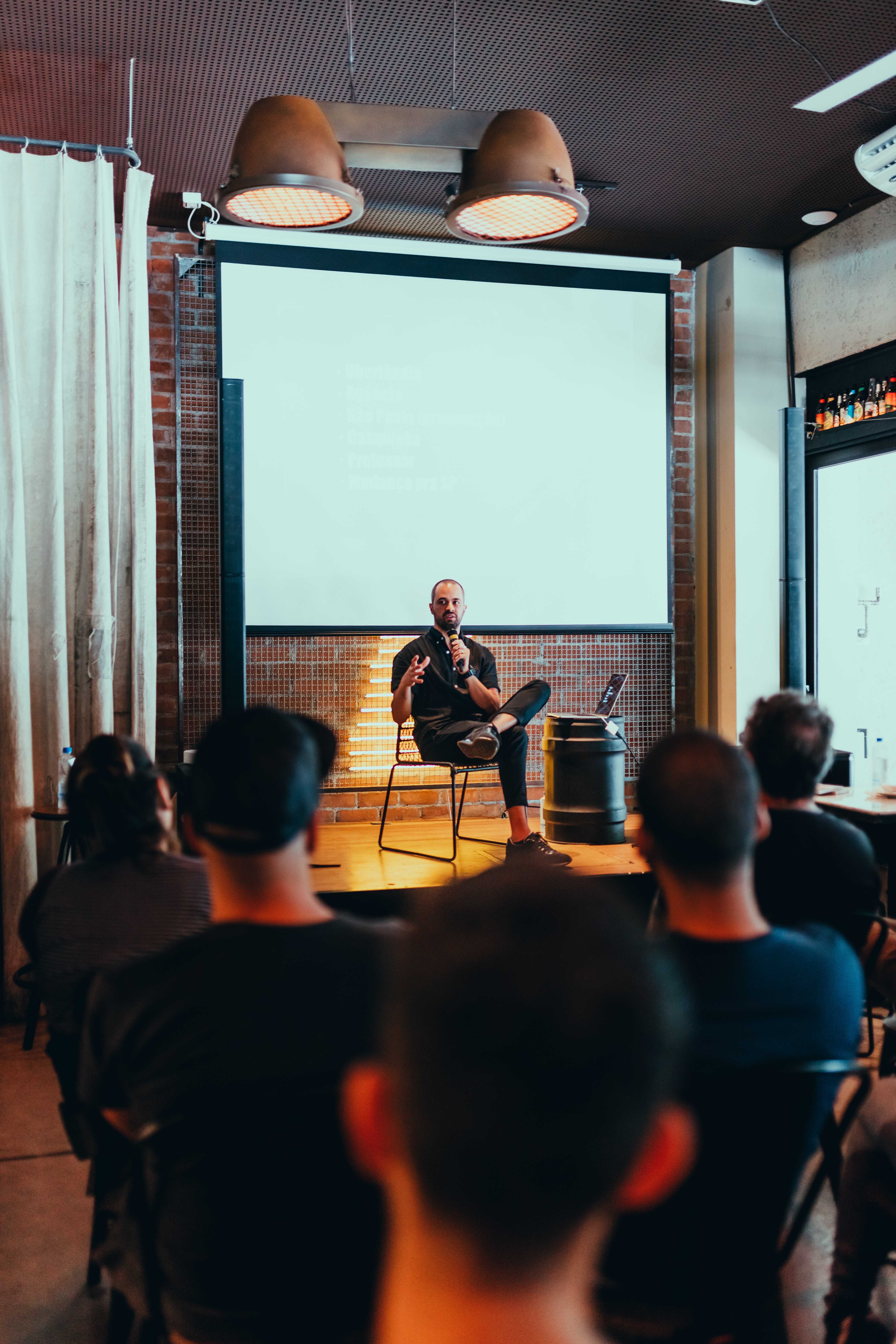 Man sitting in a chair and talking to his audience