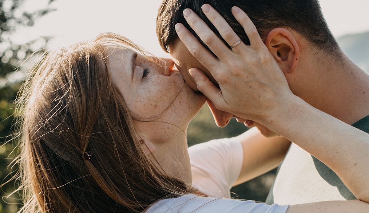 Woman giving a forehead kiss to her husband