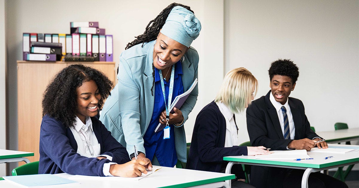 Instructor talking to her students during their Spanish lesson