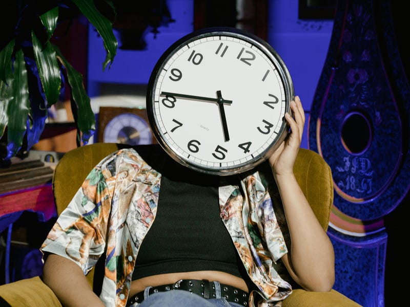 Person with a clock for a head