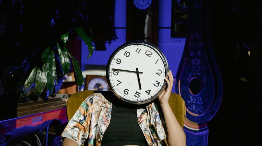 Person with a clock for a head