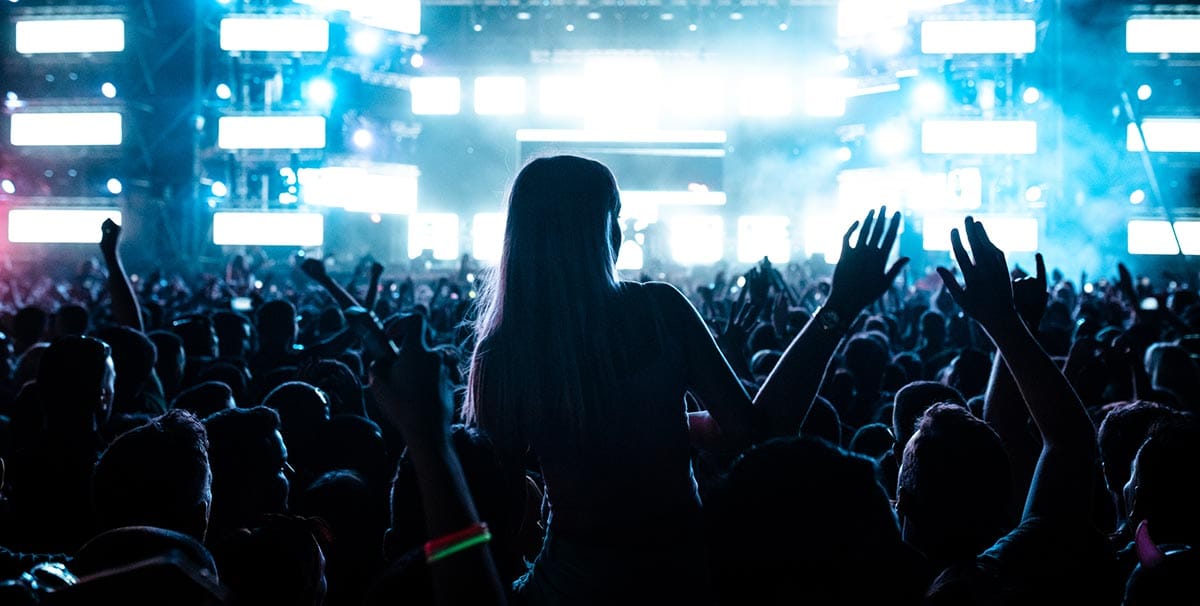 Woman arriving at a festival with pretty lights