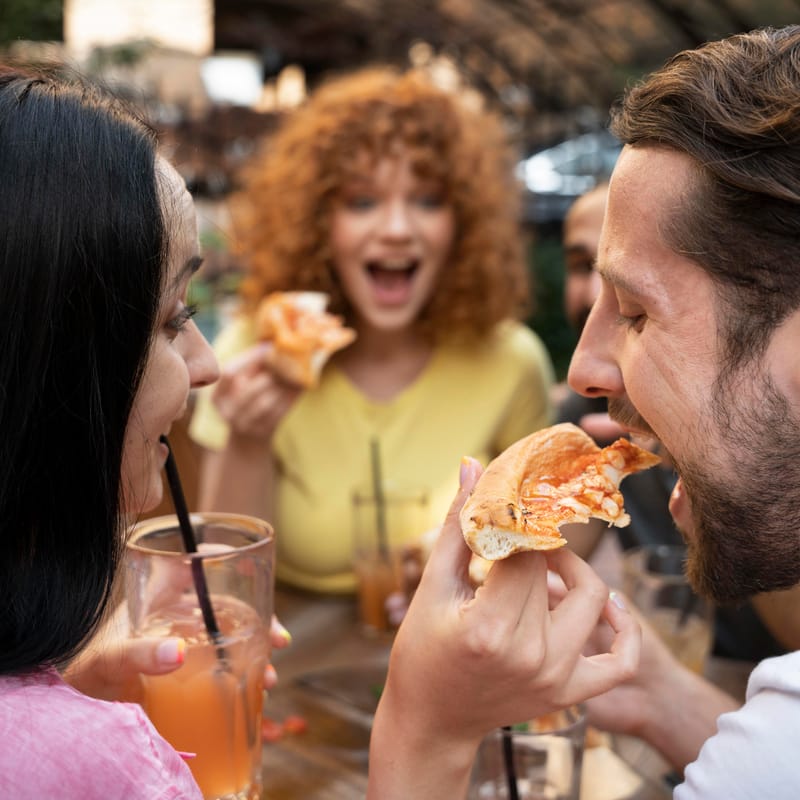 Friend group eating pizza