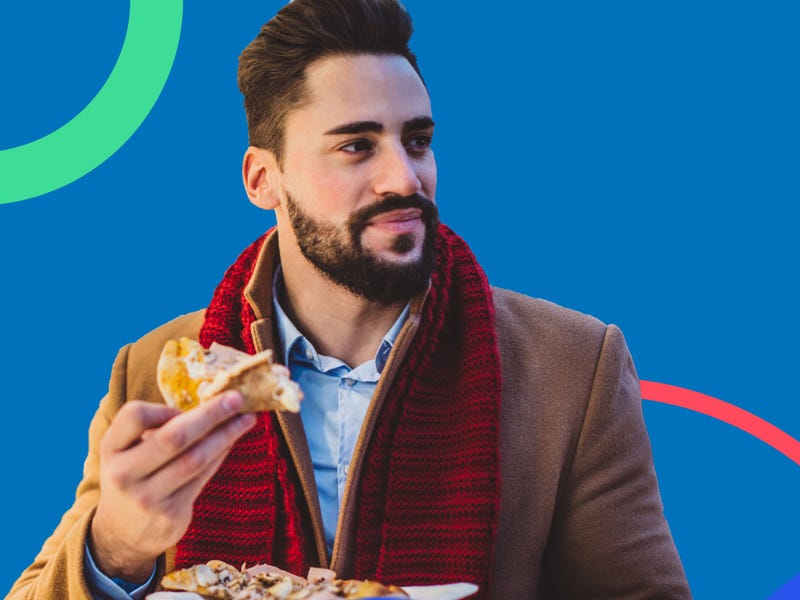 Man in a coat eating bacon and eggs