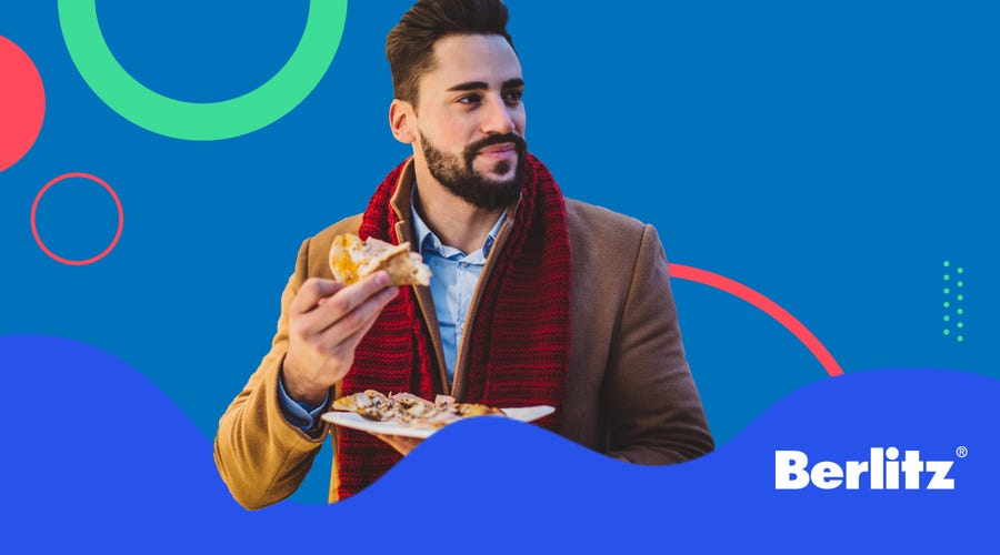 Man in a coat eating bacon and eggs