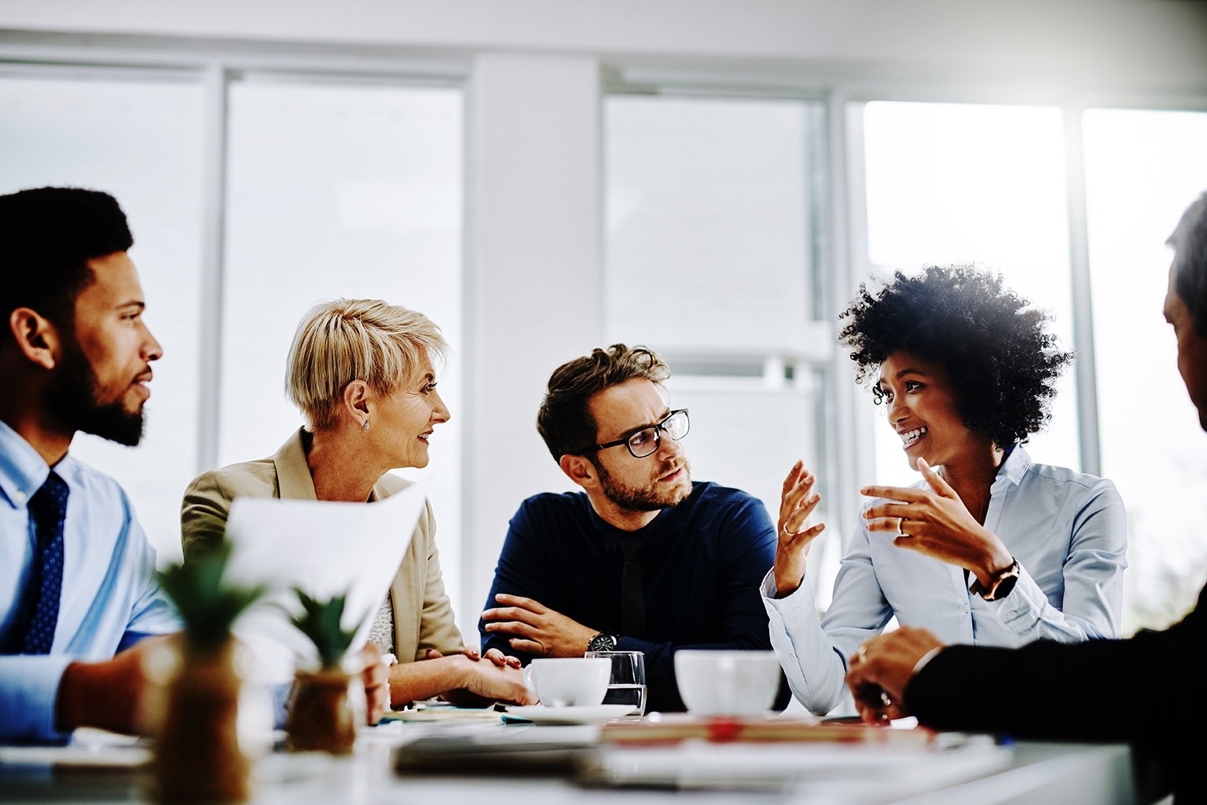People sitting around a table and talking during a business meeting