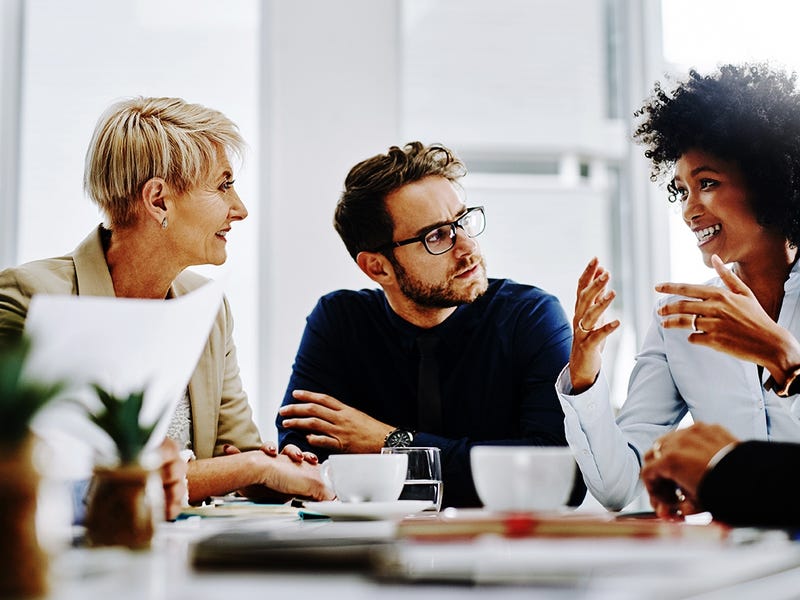 People sitting around a table and talking during a business meeting