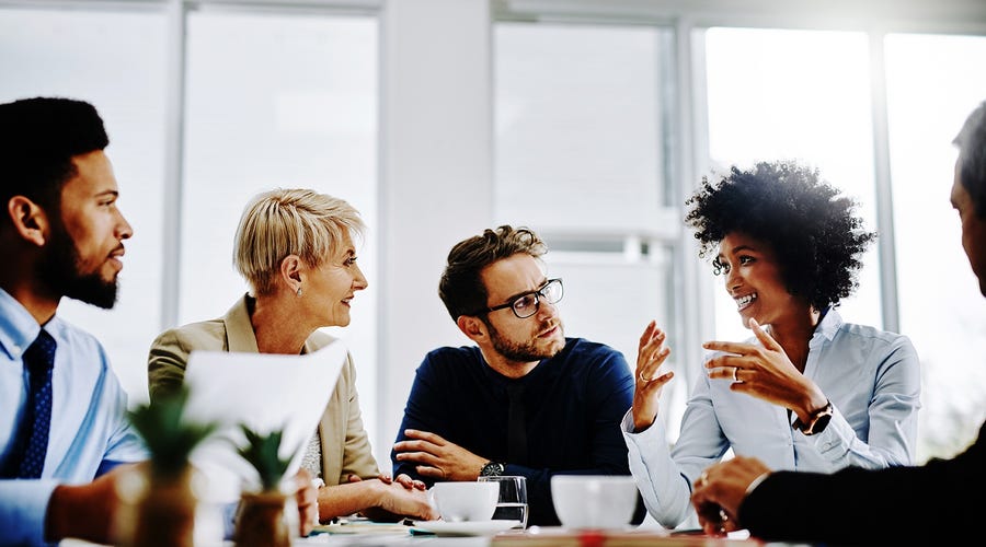 People sitting around a table and talking during a business meeting