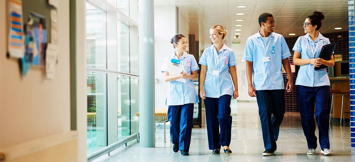Coworkers chatting with each other happily in the hospital