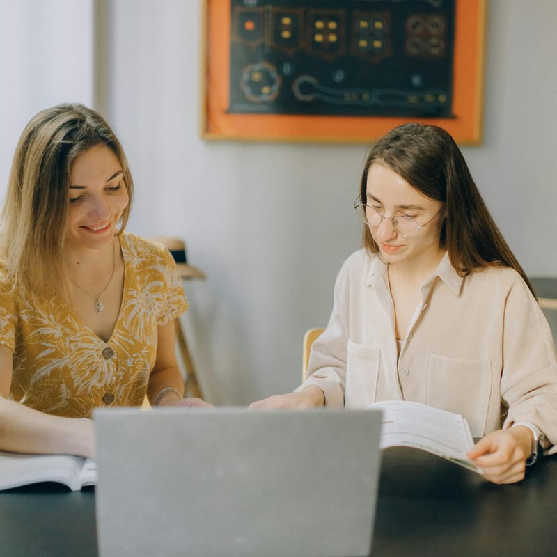 Woman with her instructor practicing future simple tense in English