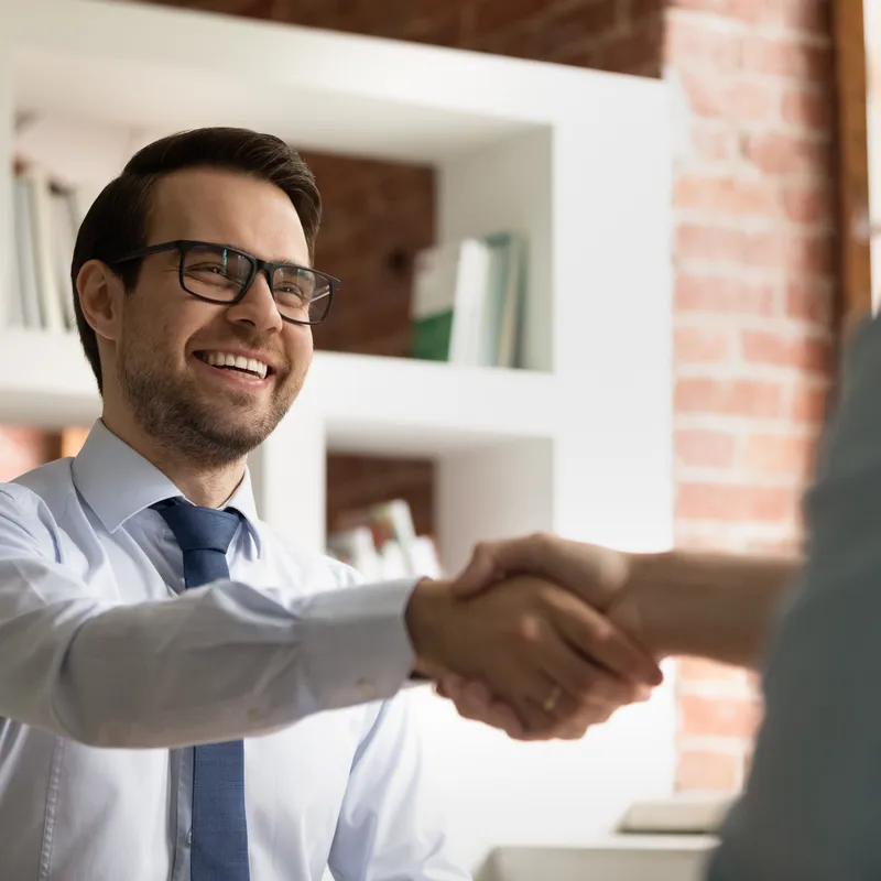 Man shaking hands with a candidate before a job interview