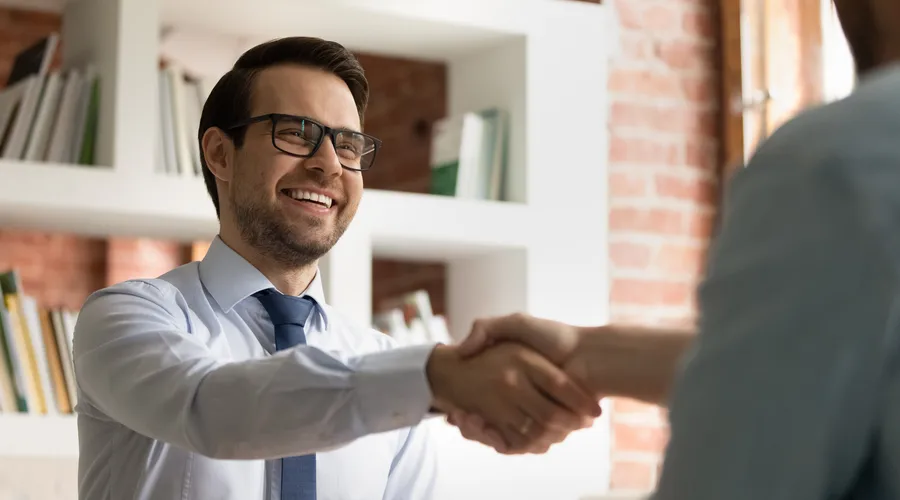 Man shaking hands with a candidate before a job interview