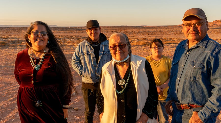 Native American family in nature smiling