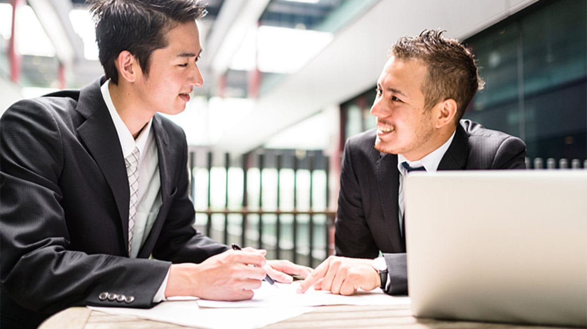 Two Italian businessmen talking to each other during a negotiation