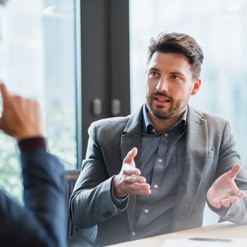 Man talking to his business partner in present simple