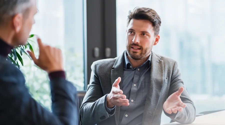Man talking to his business partner in present simple