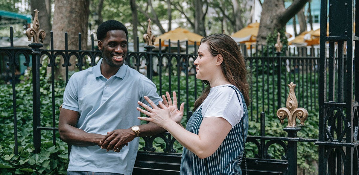 Two strangers near a park chatting
