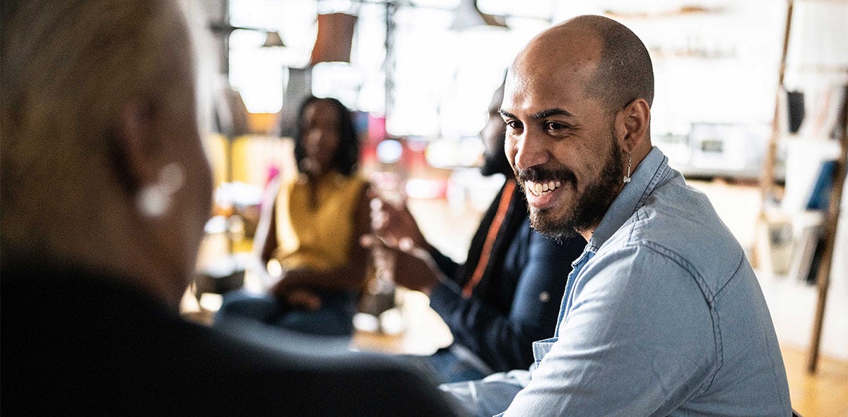 Man smiling and chatting in Italian