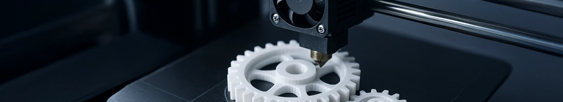 Assorted 3D printed gears in PLA filament arranged on a workbench
