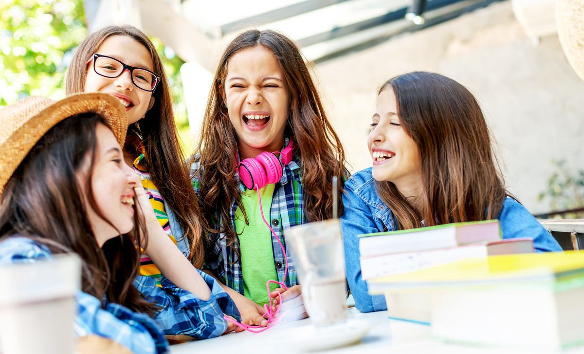 Four girls attending a group language class for kids