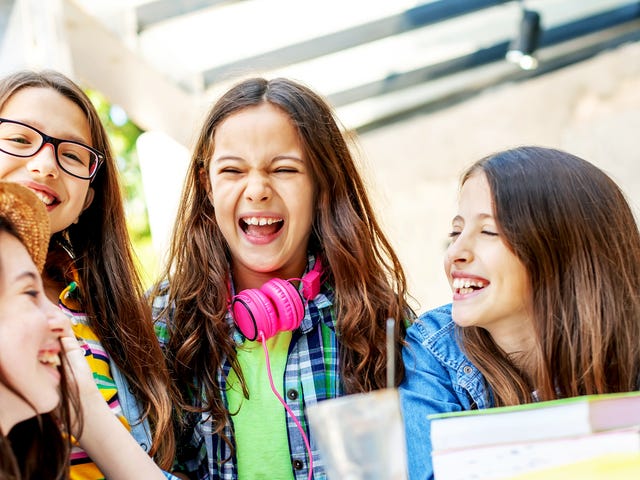 Four girls attending a group language class for kids