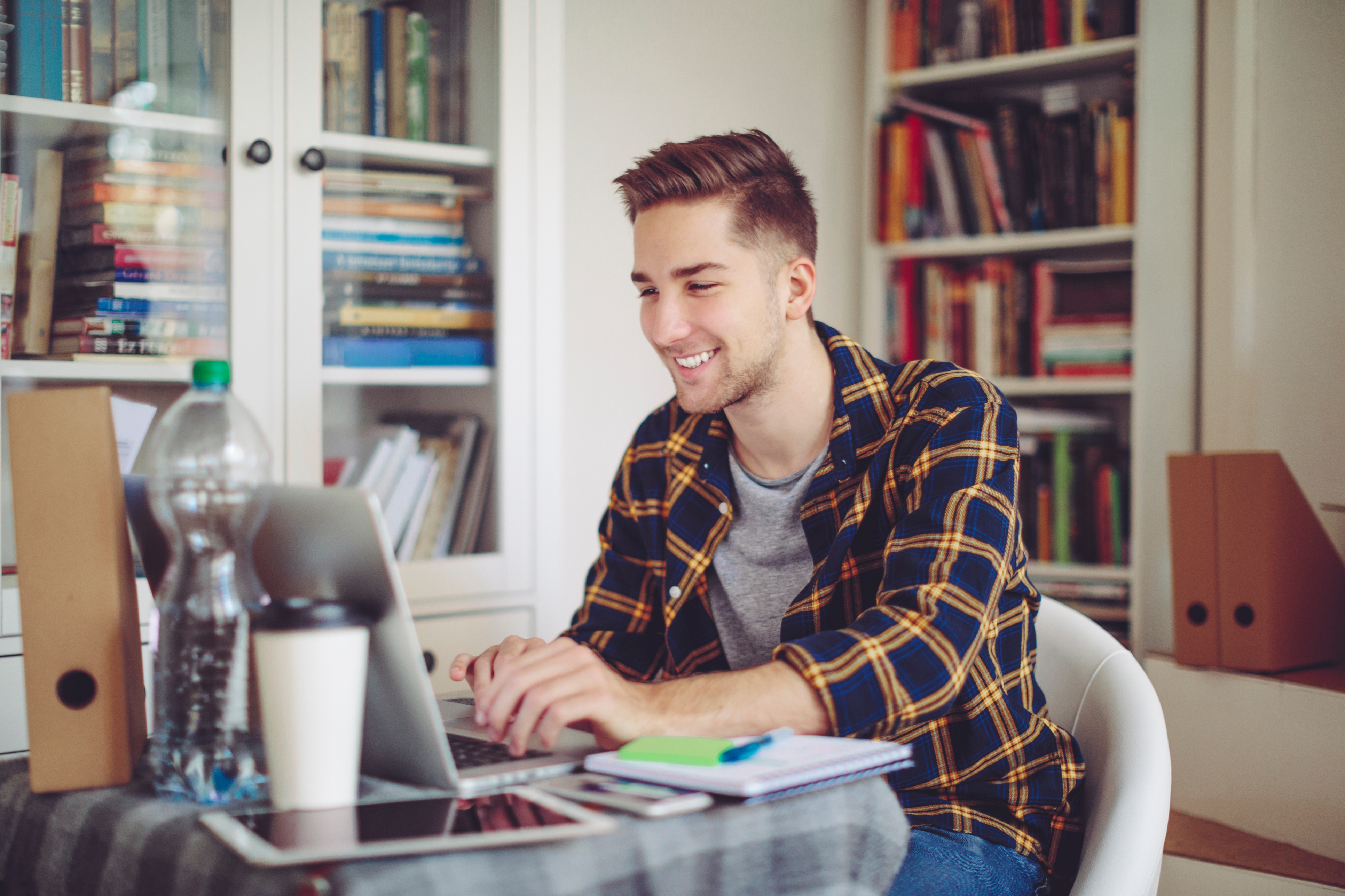 A man attending an online language class on his laptop