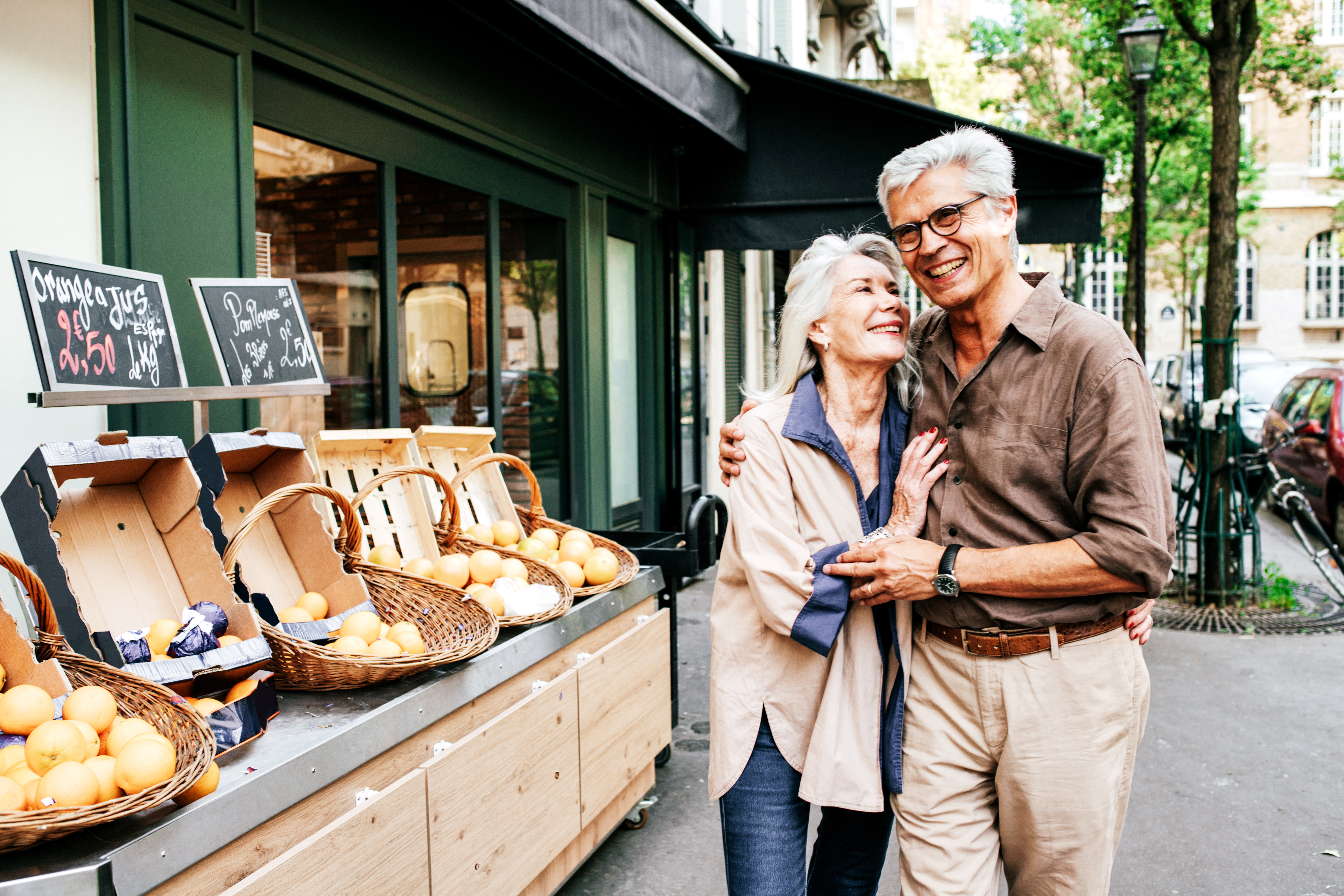 Elderly couple on the street hugging each other and saying i love you in Spanish