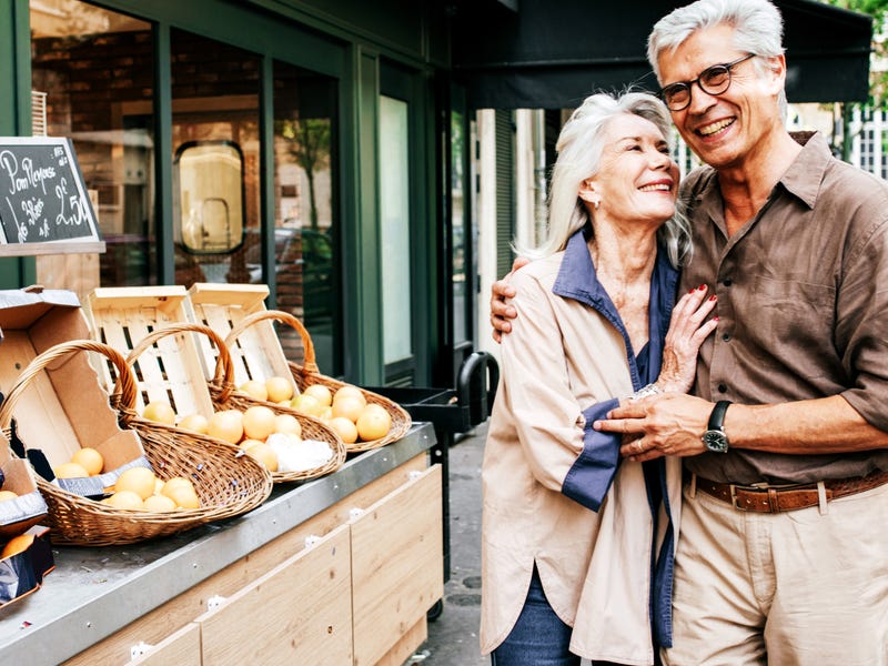 Elderly couple on the street hugging each other and saying i love you in Spanish