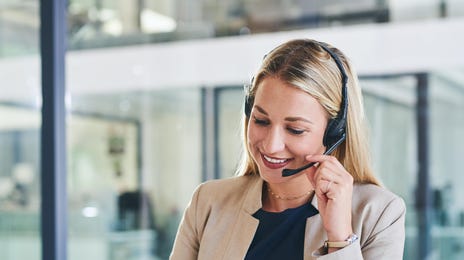 Woman with a headset learning English on her laptop