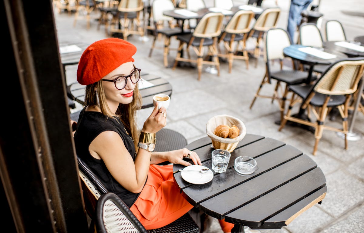 Woman drinking coffee after learning French