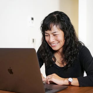 Woman in front of her laptop participating in an online Spanish class with Berlitz UAE