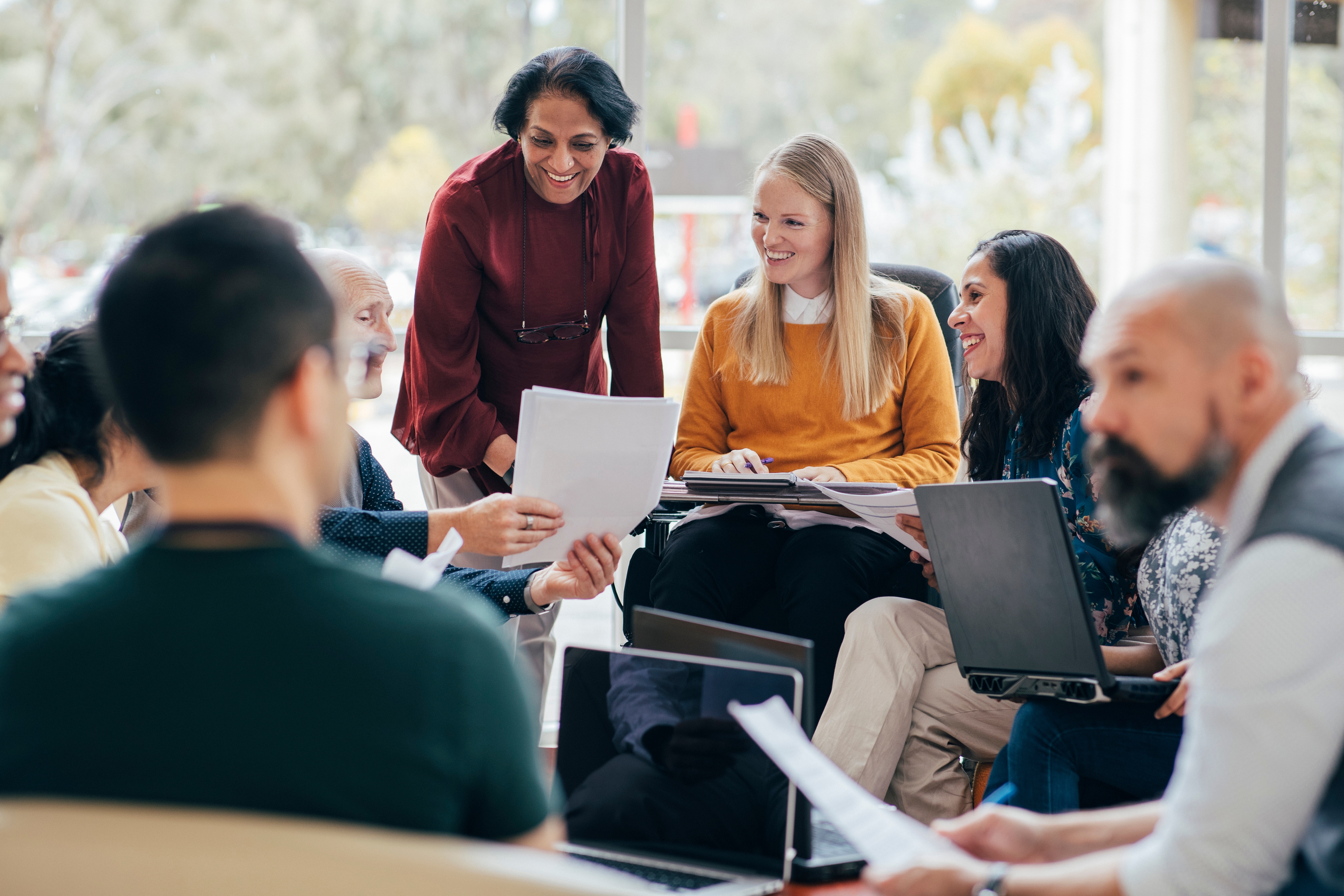 A group of students and their instructor during an in-person language course for adults